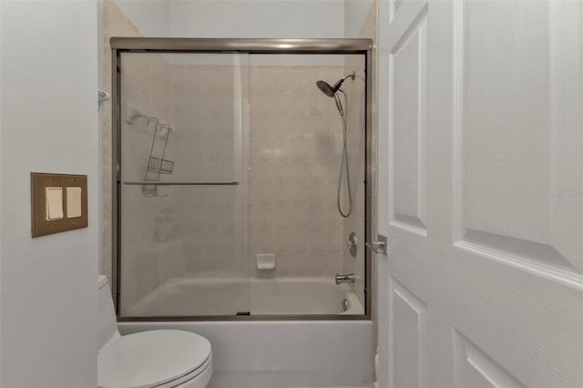 bathroom with shower / bath combination with glass door and toilet