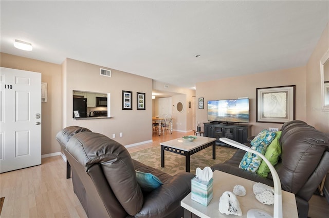 living room with light hardwood / wood-style floors