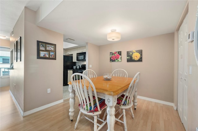 dining space featuring light hardwood / wood-style floors