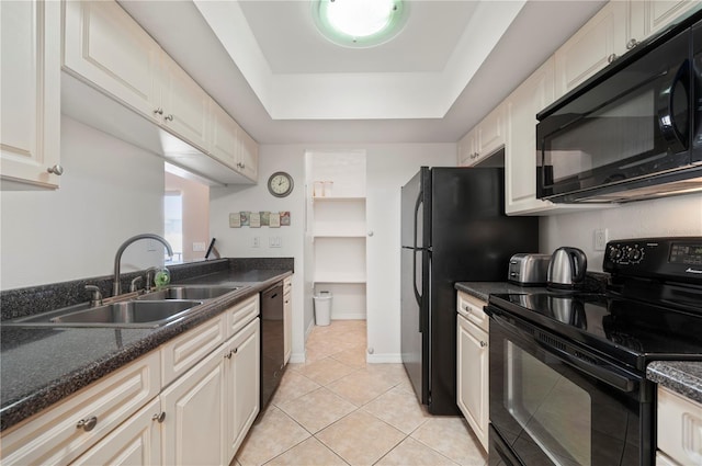 kitchen featuring white cabinetry, sink, a raised ceiling, light tile patterned floors, and black appliances