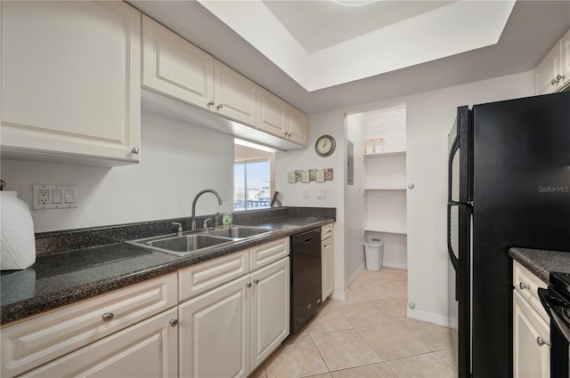 kitchen featuring sink, light tile patterned floors, and black appliances