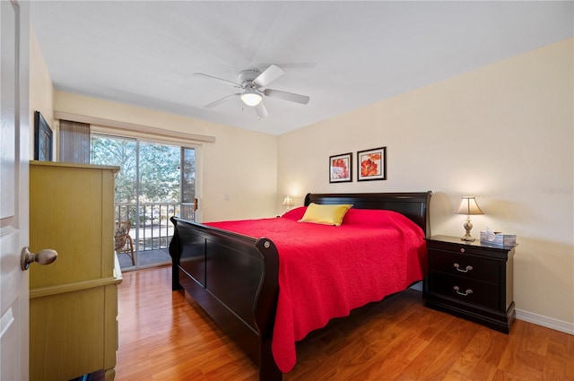 bedroom featuring hardwood / wood-style flooring, ceiling fan, and access to outside