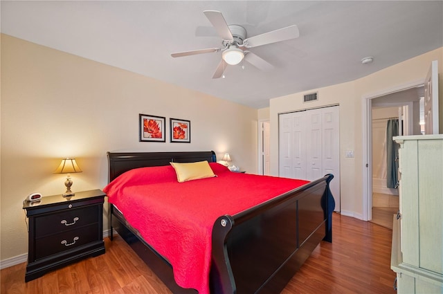 bedroom with hardwood / wood-style floors, ceiling fan, and a closet