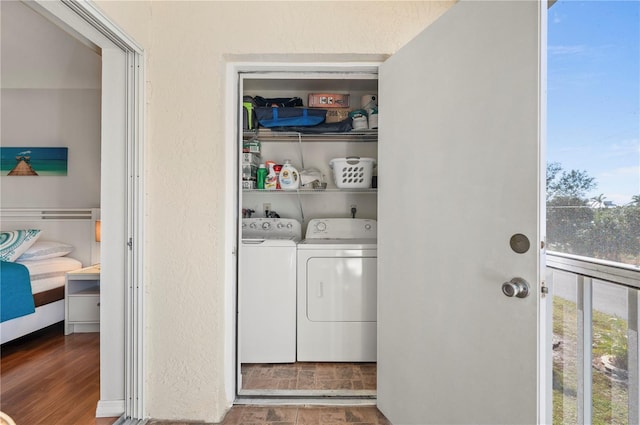 laundry room featuring washer and clothes dryer and wood-type flooring