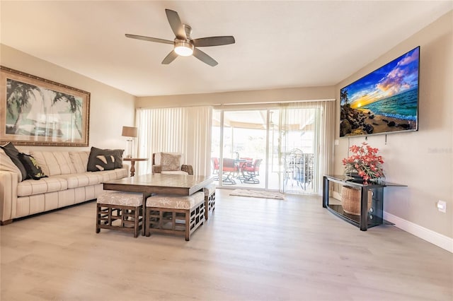 living room with light wood-type flooring and ceiling fan