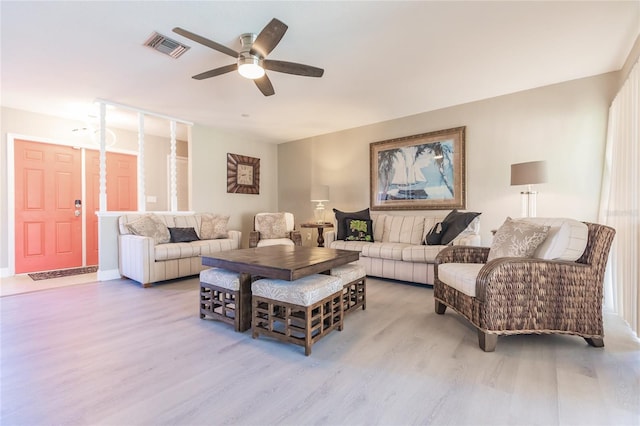 living room with light hardwood / wood-style floors and ceiling fan