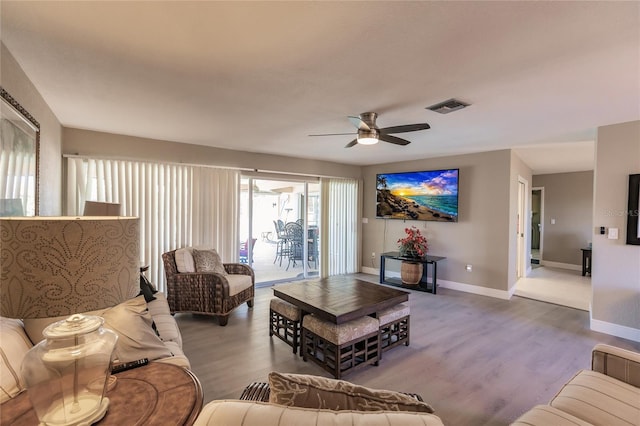 living room featuring ceiling fan and wood-type flooring