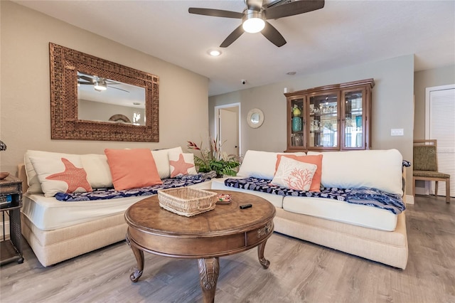 living room featuring ceiling fan and hardwood / wood-style floors