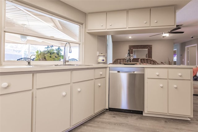 kitchen with white cabinets, stainless steel dishwasher, ceiling fan, light hardwood / wood-style floors, and kitchen peninsula