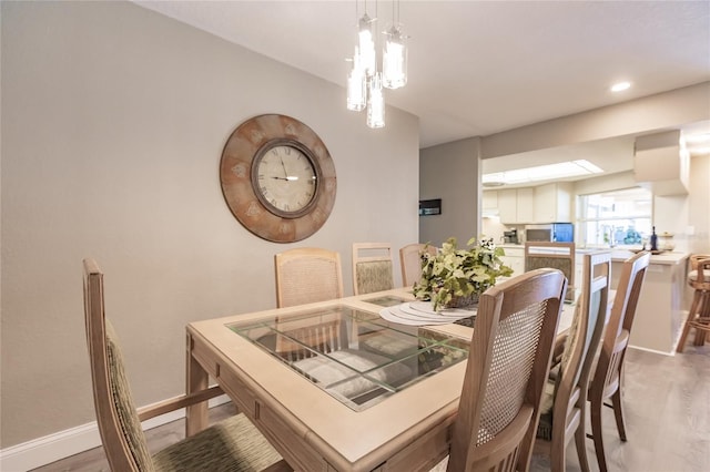 dining area featuring hardwood / wood-style flooring and a chandelier