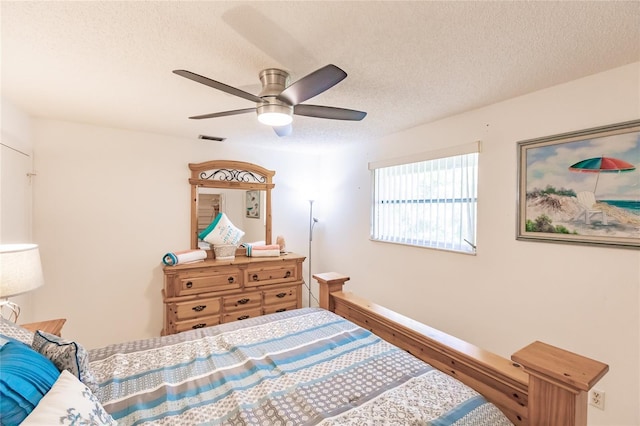 bedroom featuring wood-type flooring, a textured ceiling, and ceiling fan