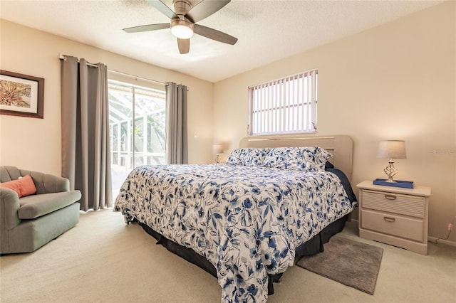 carpeted bedroom with a textured ceiling and ceiling fan