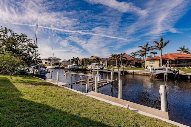 dock area with a yard and a water view