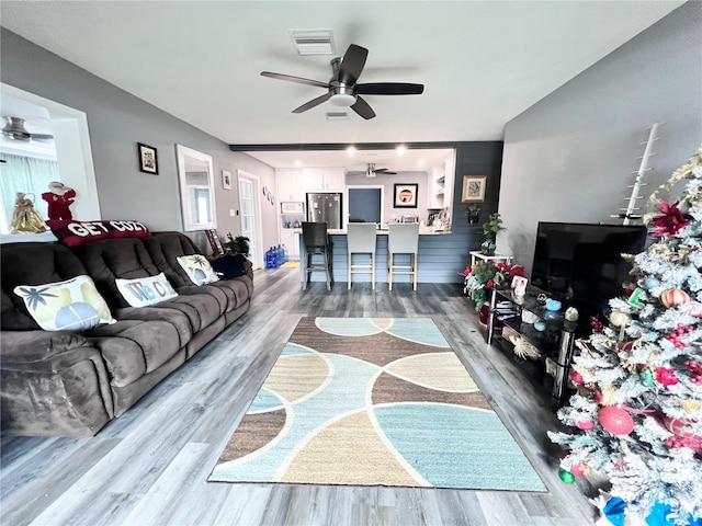 living room with ceiling fan and wood-type flooring