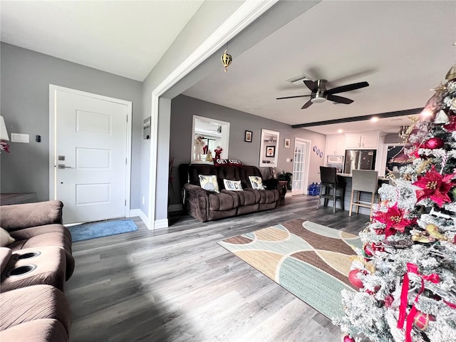 living room featuring wood-type flooring and ceiling fan