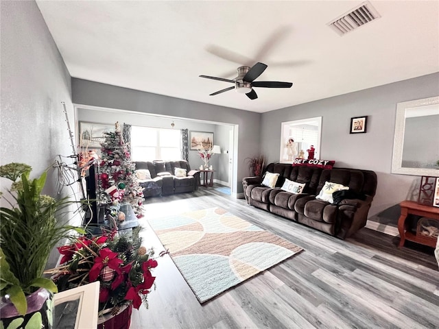 living room featuring hardwood / wood-style flooring and ceiling fan