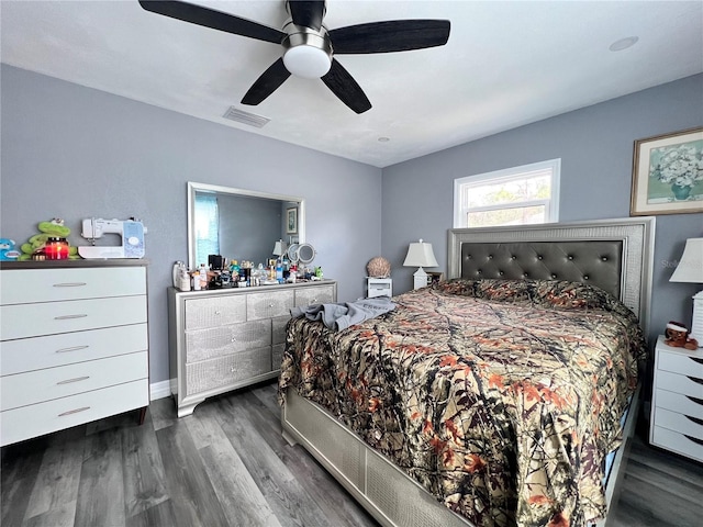 bedroom with ceiling fan and dark wood-type flooring