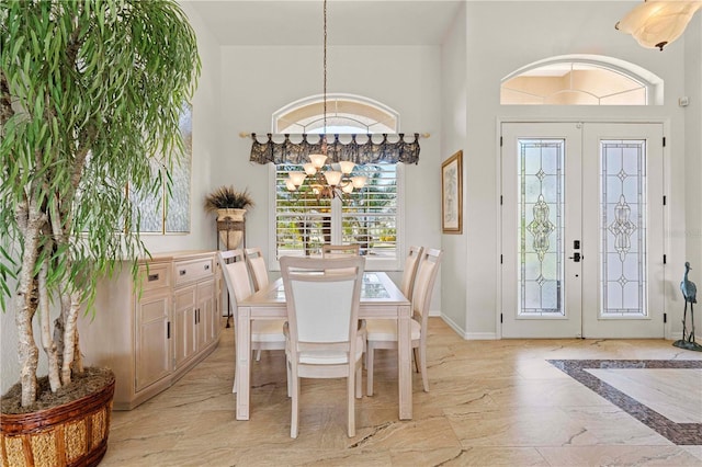 dining area with a chandelier and french doors