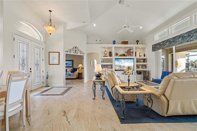 living room featuring ceiling fan, high vaulted ceiling, and french doors