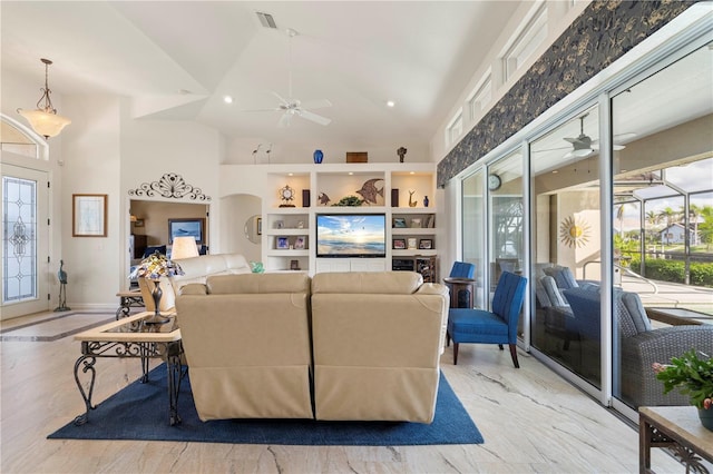 living room with ceiling fan and high vaulted ceiling