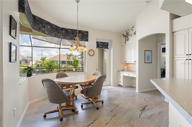 dining area featuring a notable chandelier and plenty of natural light