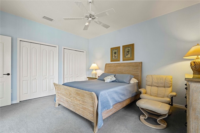 bedroom featuring carpet, ceiling fan, and multiple closets