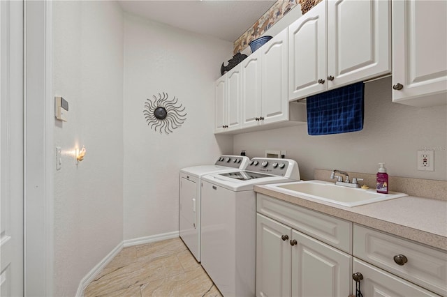 laundry area with cabinets, independent washer and dryer, and sink