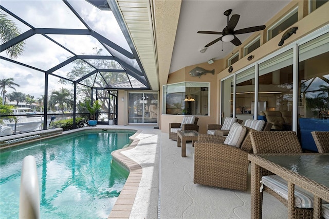 view of swimming pool with a patio, ceiling fan, and a lanai