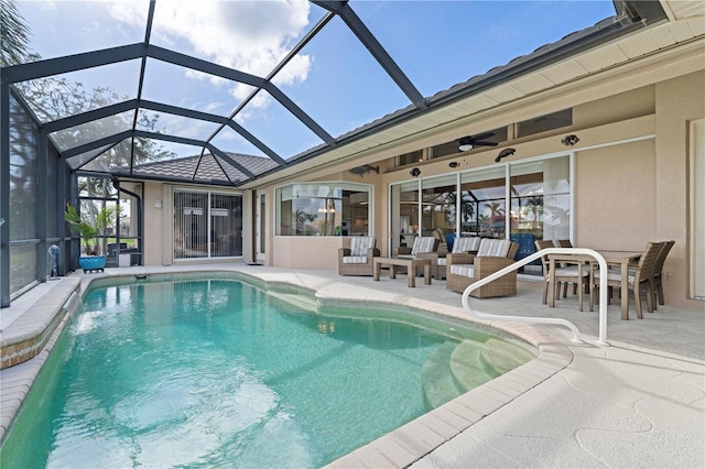 view of swimming pool featuring a lanai, a patio area, and ceiling fan