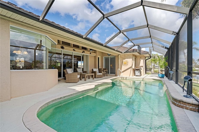 view of swimming pool featuring outdoor lounge area, a patio, and a lanai