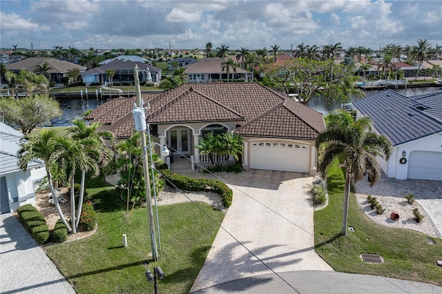 view of front of house featuring a water view, a garage, and a front yard