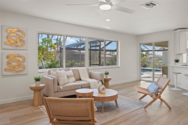 living room featuring ceiling fan and light hardwood / wood-style floors