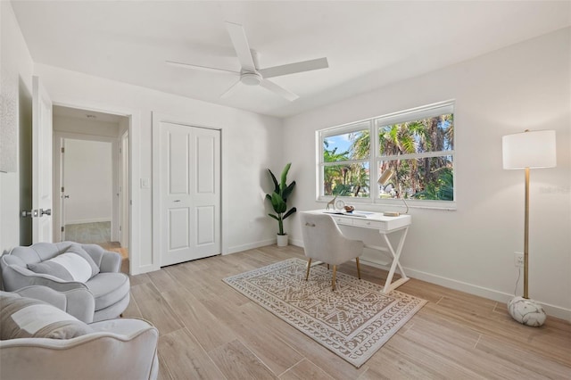 office space with ceiling fan and light hardwood / wood-style floors