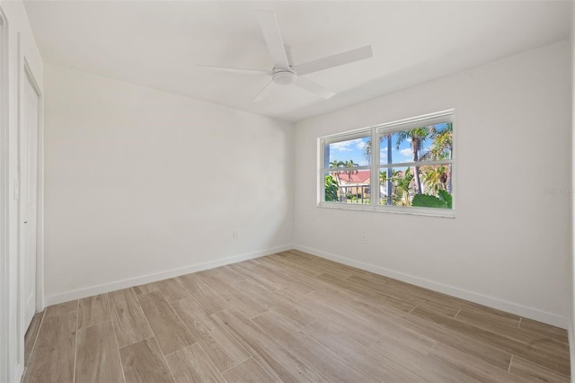 spare room featuring ceiling fan and light wood-type flooring