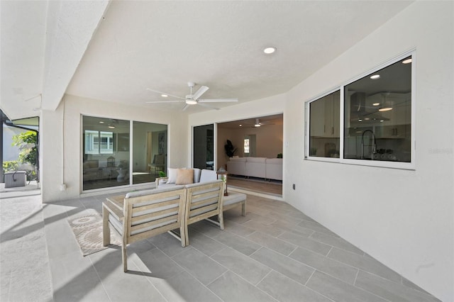 view of patio with an outdoor living space and ceiling fan