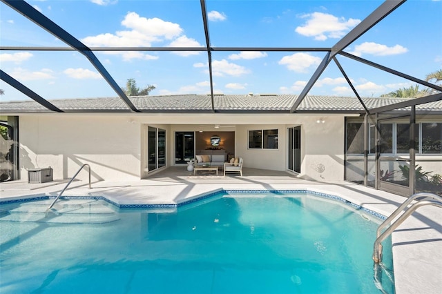 exterior space featuring glass enclosure, outdoor lounge area, and a patio