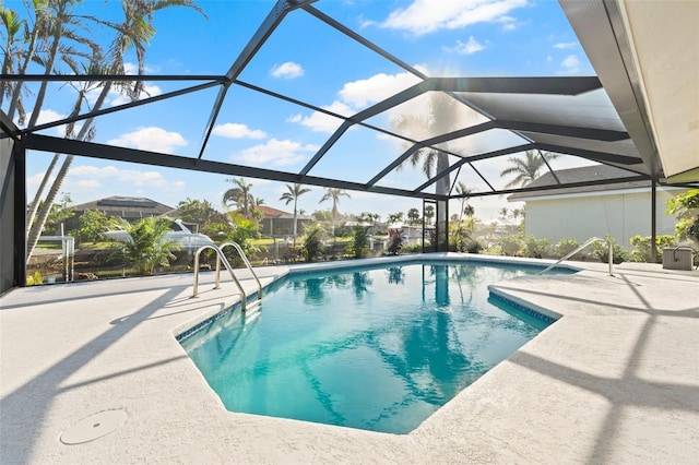 view of swimming pool with a patio area and a lanai