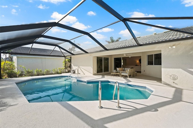 view of swimming pool with an outdoor living space, a patio, glass enclosure, and ceiling fan