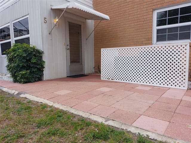 view of exterior entry featuring a patio