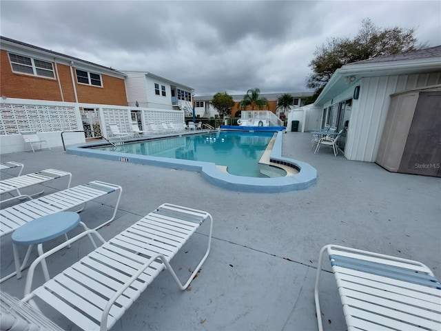 view of swimming pool featuring a patio