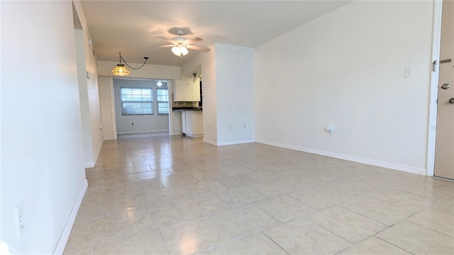 unfurnished living room with ceiling fan and light tile patterned flooring