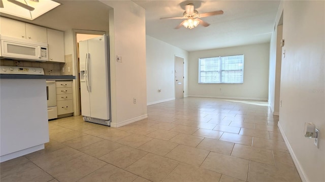 kitchen featuring white cabinetry, ceiling fan, white appliances, decorative backsplash, and light tile patterned floors