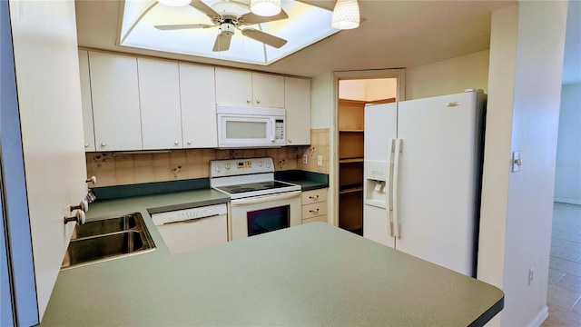 kitchen with kitchen peninsula, backsplash, white appliances, sink, and white cabinetry