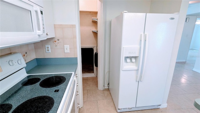 kitchen featuring tile walls, white cabinetry, light tile patterned flooring, and white appliances