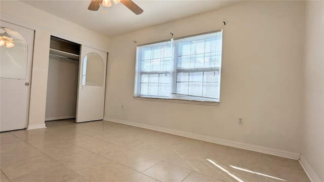 unfurnished bedroom with a closet, ceiling fan, and light tile patterned flooring