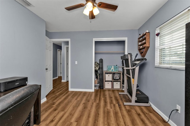 exercise room with hardwood / wood-style floors and ceiling fan