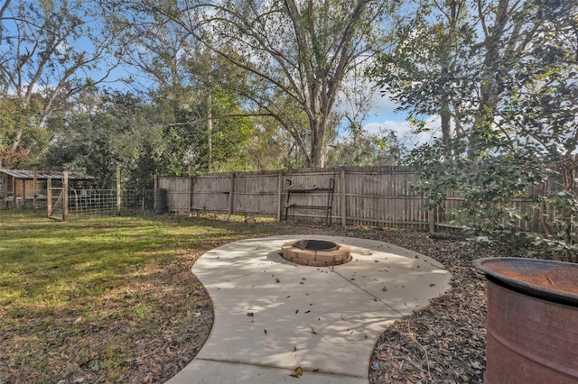 view of yard with a patio and an outdoor fire pit