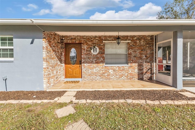 doorway to property featuring covered porch