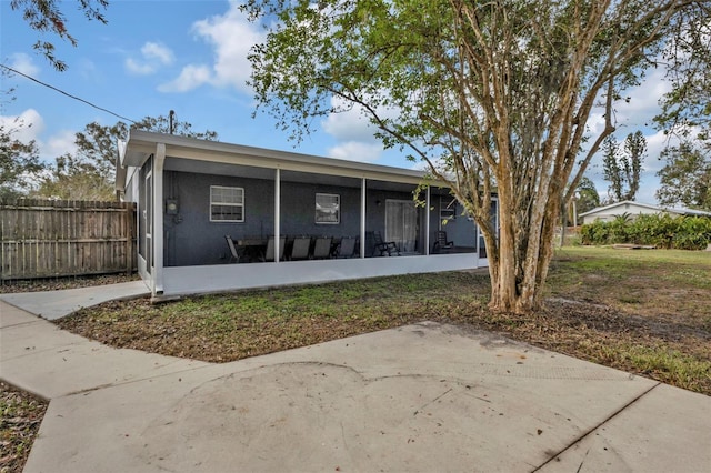 back of property with a sunroom