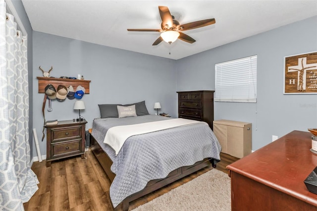 bedroom featuring ceiling fan and dark hardwood / wood-style floors